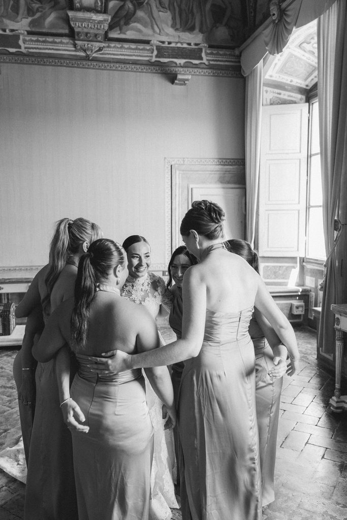 Bride and bridesmaids celebrating together before a destination wedding in Italy